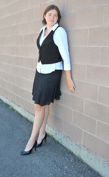 Female nanny in uniform taking a break outside.