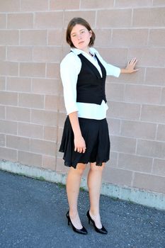 Female nanny in uniform taking a break outside.