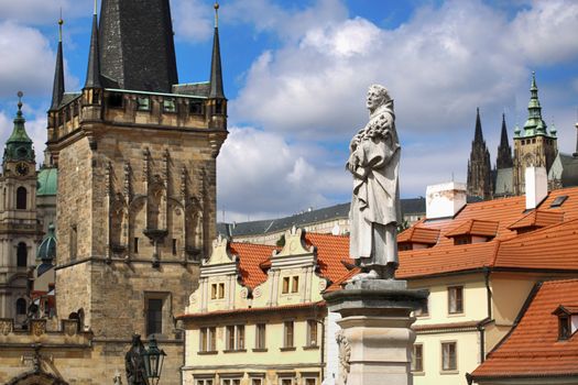 View of Statue of St. Philip Benitius and Lesser Bridge Tower and St. Vitus Cathedral and Cathedral of Saint Nicolas from the Charles Bridge (Karluv Most) in Prague, Czech Republic 