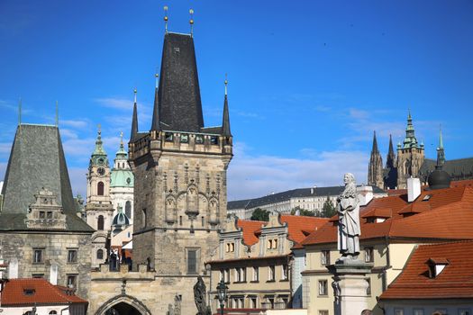 View of the Lesser Bridge Tower and St. Vitus Cathedral and Cathedral of Saint Nicolas from the Charles Bridge (Karluv Most) in Prague, Czech Republic 