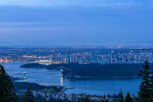 Vancouver British Columbia Canada cityscape by Stanley Park Lions Gate Bridge during early morning dawn blue hour 