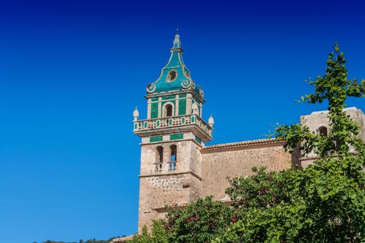 Beautiful view. Tower of the Monastery of Valldemossa in the Sierra de Tramuntana Mountains with park.