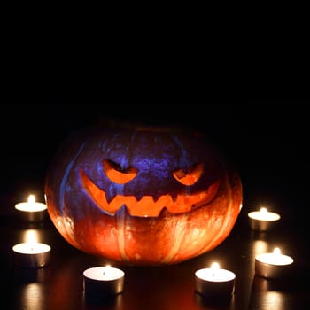 Illuminated cute halloween pumpkin isolated on black background