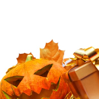 Halloween pumpkin with autumn leafs and gift isolated on white