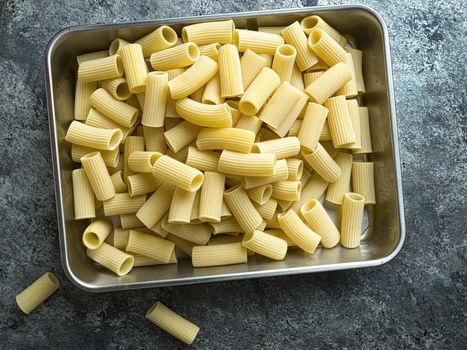 close up of rustic uncooked italian rigatoni pasta
