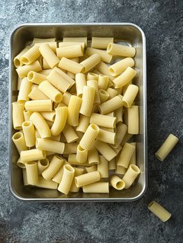 close up of rustic uncooked italian rigatoni pasta