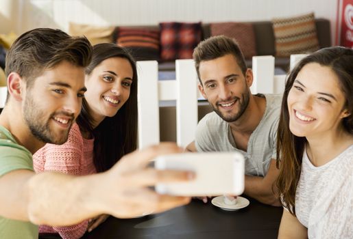 Group of friends at the coffee shop making a selfie together 