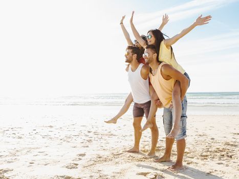 Group of friends having fun at the beach