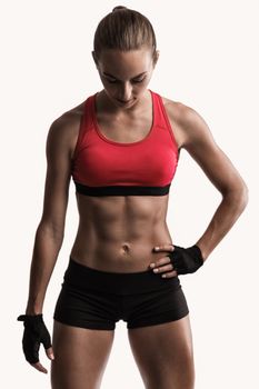 Studio portrait of a sporty young woman posing against a gray background