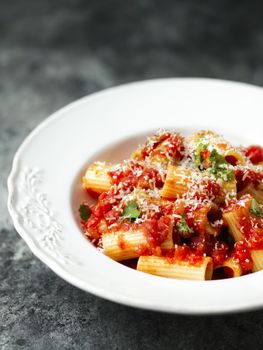 close up of rustic italian rigatoni pasta in tomato sauce