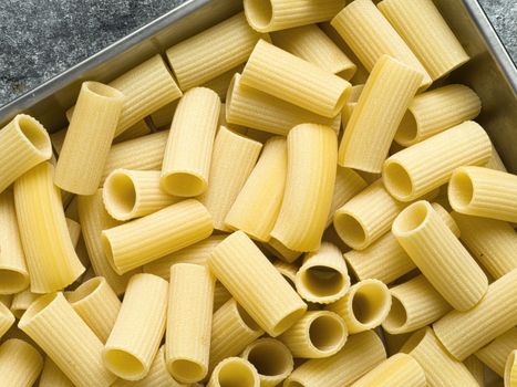 close up of rustic uncooked italian rigatoni pasta