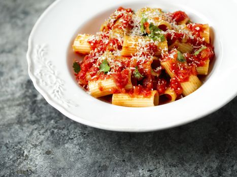 close up of rustic italian rigatoni pasta in tomato sauce