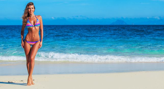 Pretty slim girl at tropical sea beach