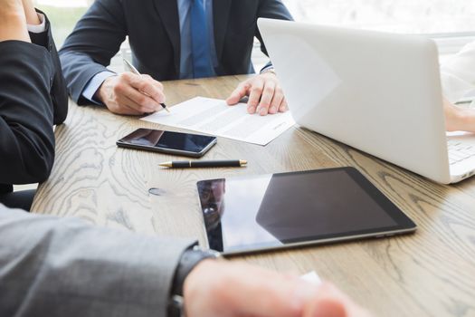 Business people work with documents and computers at office table close up