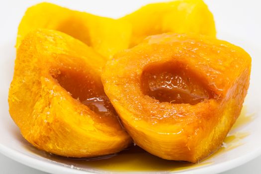 Chontaduro (Bactris gasipaes) with honey isolated on white background