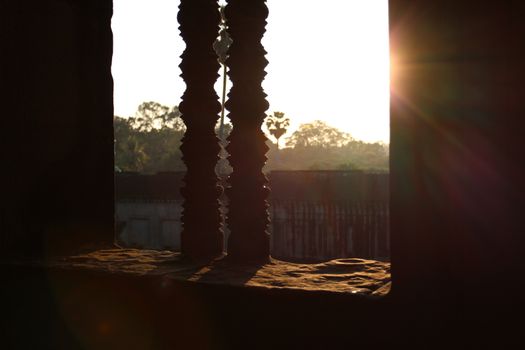 sunlight through the patterned window of the Cambodian temple