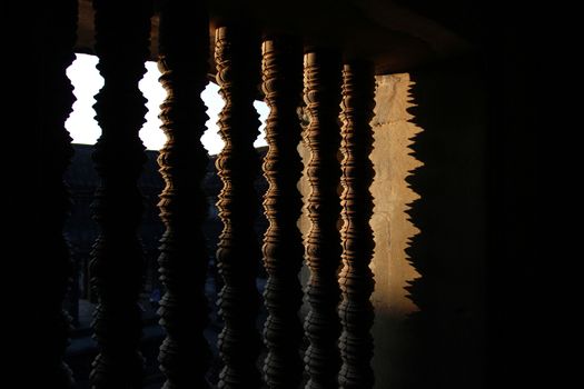 sunlight through the patterned window of the Cambodian temple