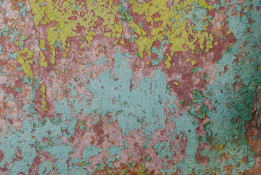 fragment of a rusty iron surface covered with old paint, which has long been under the influence of different climatic conditions