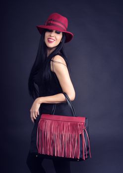 style girl smiling with shopping bags and red hat