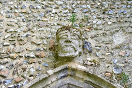 an old carved stone face on a wall