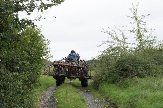 a farmer drives a tractor on country farmland