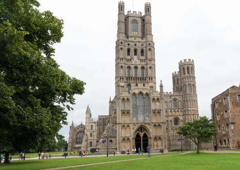 exterior of Ely cathedral from the green with trees