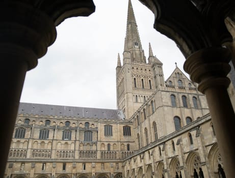 Norwich cathedral from the courtyard through cloister columns