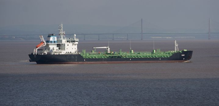 Freight ship at sea passing the Severn Crossing in the Bristol Channel