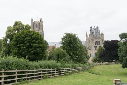 exterior of Ely from the pathway with fencing and trees