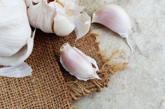 Dry garlic on sack and cement floor.