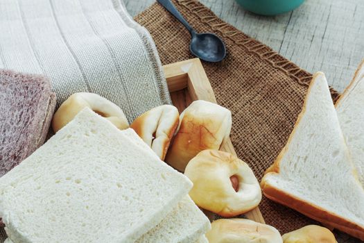 Many breads and coffee on tablecloths.