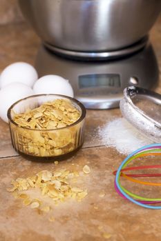 three eggs,sliced almonds and gray metal scale,sieve flour and colorful whip