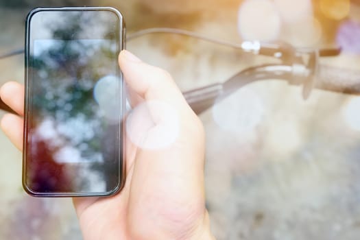 image of a biker texting on a smart phone