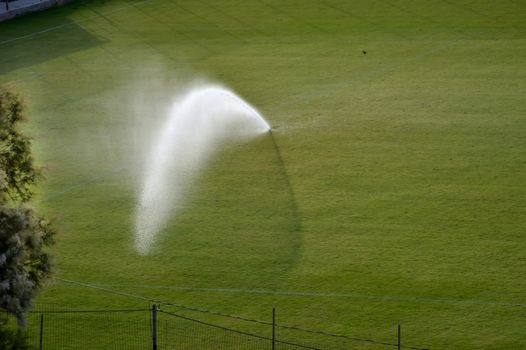 Automatic watering of a lawn in a football field