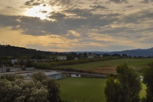 Sunset on the outskirts of the town of Maleme in Crete mountain in the background