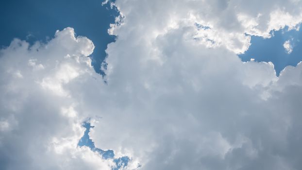 White fluffy clouds on a blue sky background