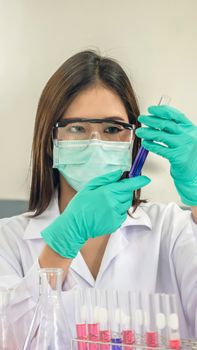 Portrait of Asian scientific researcher working in laboratory