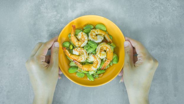 top view of Stir-Fried Twisted Cluster Bean with Shrimps/Butter Bean on orange dish