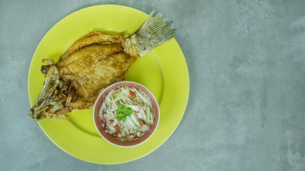 Deep fried fish with green mango salad