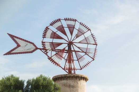 Old windmill against blue sky