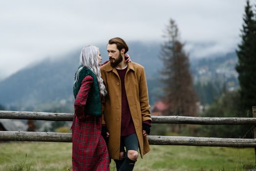 pair of lovers in the Carpathian mountains in national costumes