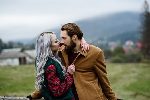 pair of lovers in the Carpathian mountains in national costumes