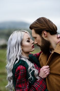 pair of lovers in the Carpathian mountains in national costumes