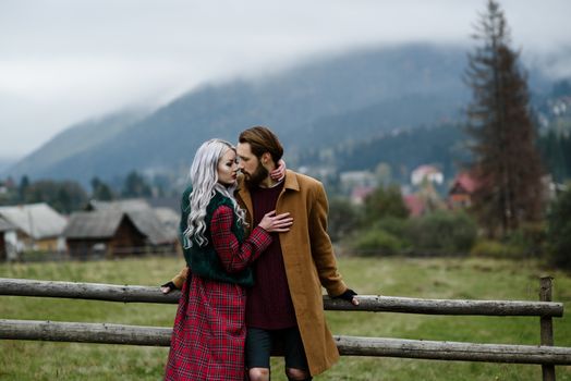 pair of lovers in the Carpathian mountains in national costumes