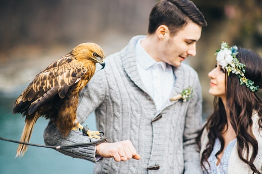 Сouple of newlyweds in the Carpathian waterfall, a wedding walk