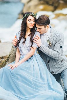 Сouple of newlyweds in the Carpathian waterfall, a wedding walk