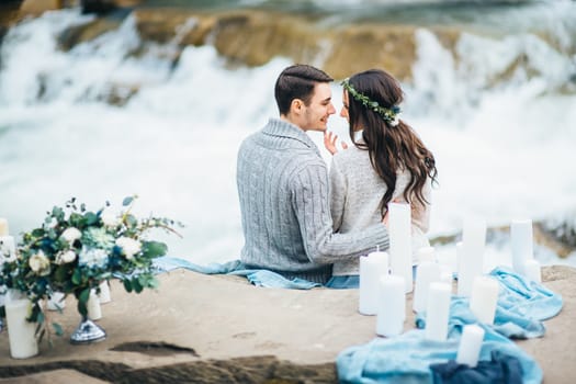 Сouple of newlyweds in the Carpathian waterfall, a wedding walk