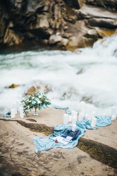 Сouple of newlyweds in the Carpathian waterfall, a wedding walk