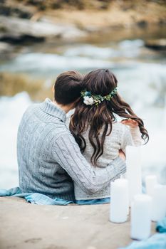 Сouple of newlyweds in the Carpathian waterfall, a wedding walk