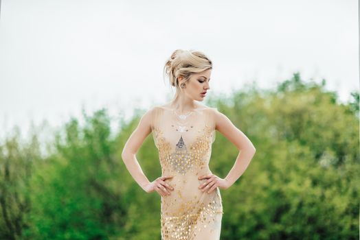 model girl dress gold angel posing in the woods near the old columns